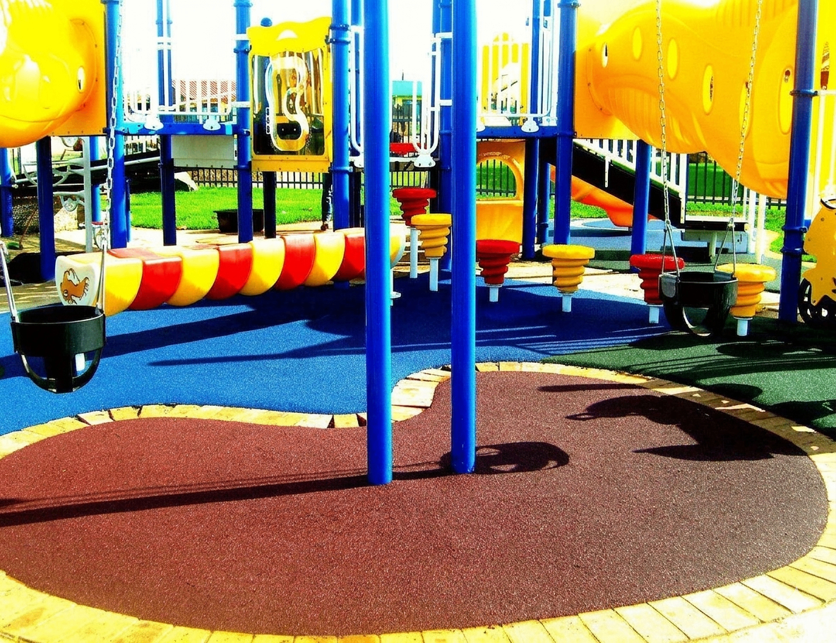 Yellow and blue playground with multi-colour rubber zones
